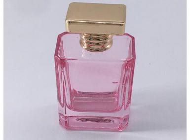 bottiglia di profumo rosa vuota